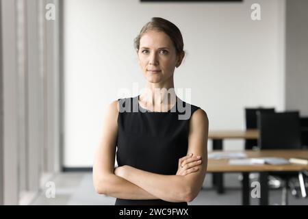 Serious attractive young businesswoman posing in office space Stock Photo