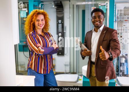 Portrait of young couple who owns small business bath store. Man and woman work in partnership. Stock Photo