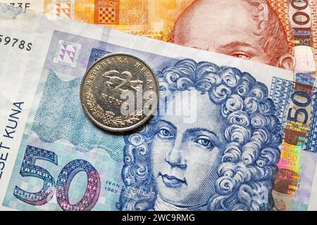 Close-up on a coin on top of a banknote of 50 an 100 Croatian Kuna. Stock Photo