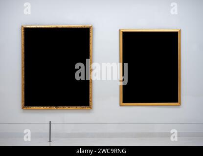 Mockup two blank space in gold vertical square artist painting frame, isolated. Empty 2 Asian style of luxury golden photo frame hanging on white wall Stock Photo