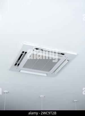Ceiling mounted cassette type air conditioner decoration near ceiling lights on white building interior, vertical style. Ceiling type of air condition Stock Photo