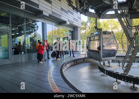Tourist families wait to get on one of the cable cars going up the mountain to the amusement park area of Koke Tobe. In Almaty, Kazakhstan. Stock Photo