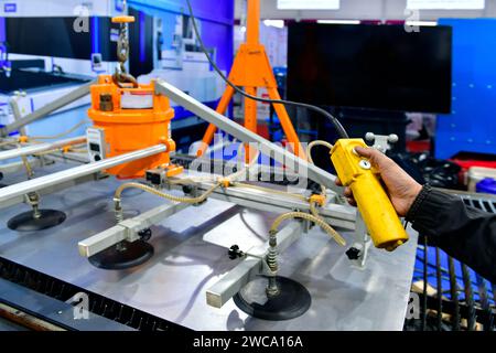 A worker is pressing a steel plan control button to enter the steel cutting process in the industrial factory Stock Photo