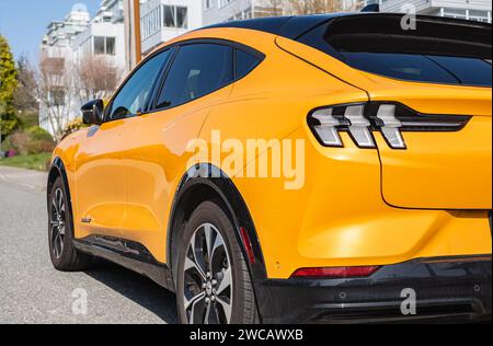 Yellow muscle car Ford Mustang. Headlights of yellow modern car. Back view. Ford Mustang GT parked on road side. Street photo, nobody-Vancouver Canada Stock Photo