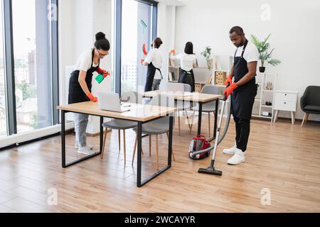 Team of young multicultural cleaners . Stock Photo