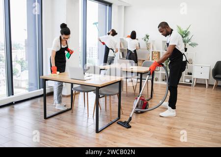 Team of young multicultural cleaners . Stock Photo