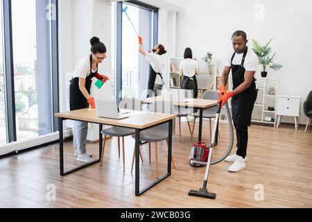 Team of young multicultural cleaners . Stock Photo