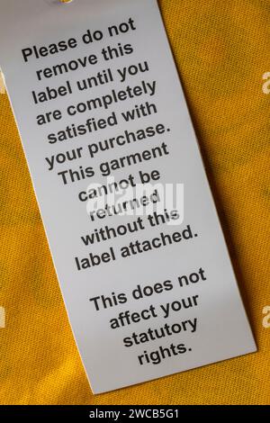 please do not remove this label until you are completely satisfied with your purchase label on BBC Children in Need Pudsey t-shirt Stock Photo