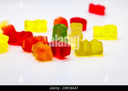 The multi-colored gummy bears arranged on a pristine white surface Stock Photo