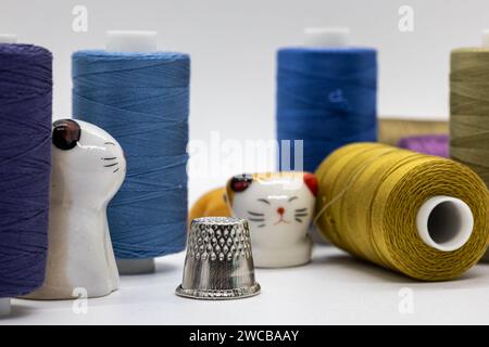 A colorful assortment of thread spools neatly stacked on top of each other in a vibrant display Stock Photo
