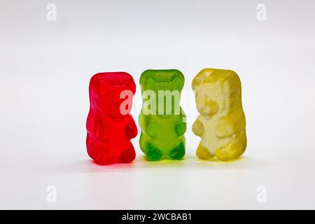 A vibrant and colorful arrangement of gummy bears is showcased against a clean, white backdrop Stock Photo
