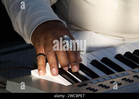Close up of a Black musician’s hand playing an electronic piano. Stock Photo