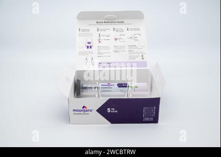 POTTERVILLE, MI - JANUARY 14, 2024: Mounjaro tirzepatide prescription open box with injection pen isolated on a white Stock Photo