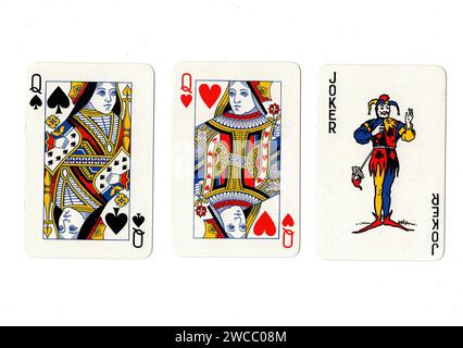 Vintage playing cards showing a pair of queens and a joker isolated on a white background. Stock Photo