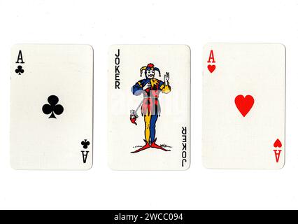 Vintage playing cards showing a pair of aces and a joker isolated on a white background. Stock Photo