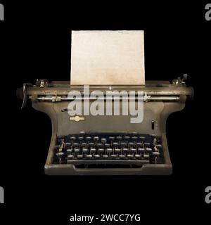 Vintage typewriter with empty sheet of weathered paper on a black background Stock Photo