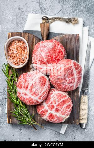 Raw Caul Fat Meatballs burger cutlets, fresh meat. Gray background. Top view. Stock Photo