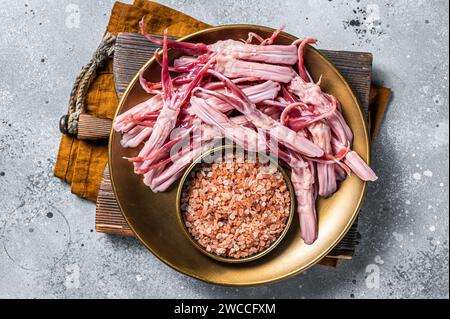 Fresh Raw Duck Tongue ready for cooking. Gray background. Top view. Stock Photo