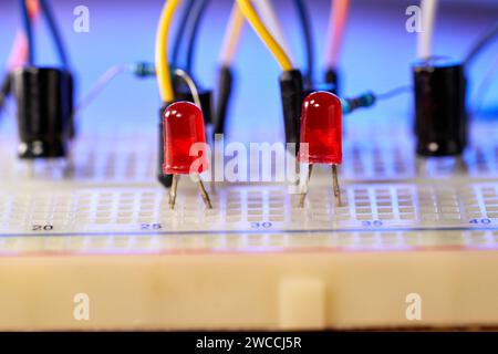 Breadboard with electrical elements, on wooden table. Stock Photo