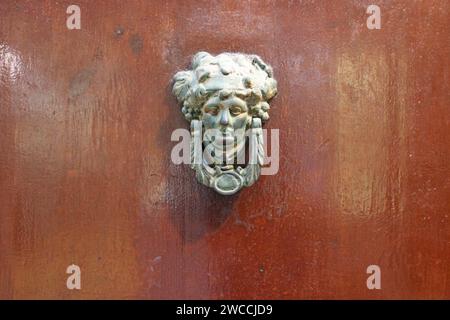 old wood door and metal knocker in rethymno in crete in greece Stock Photo