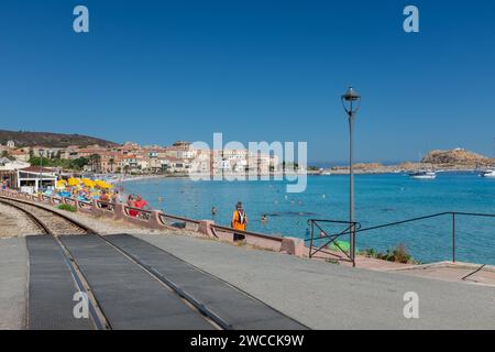 Ile Rousse, Corsica, 2017. The train tracks running along the beach, with the Ile de la Pietra and the lighthouse in the background Stock Photo