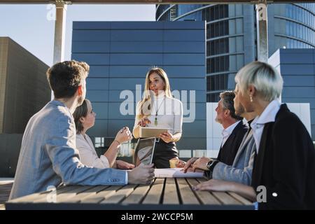 Middle age woman leading business creative team in mobile application software design project. Brainstorm meeting, work together, internet technology, Stock Photo