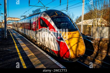 LNER Inter-City express passing through Carluke station, South Lanarkshire, Scotland at speed Stock Photo