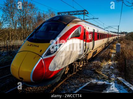 LNER Inter-City express passing through Carluke station, South Lanarkshire, Scotland at speed Stock Photo