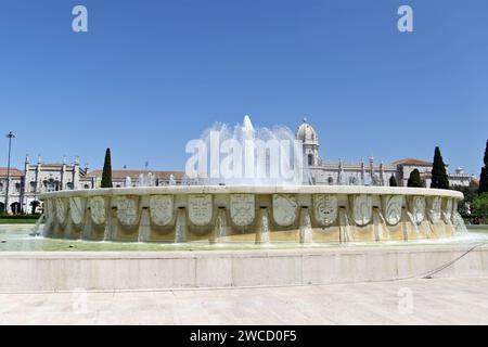 Taken from behind the fountain in the Jardim da Praça do Império which is a garden located in Lisbon. The Jerónimos Monastery or Hieronymites Monastery is a former monastery of the Order of Saint Jerome near the Tagus river in the parish of Belém, in the Lisbon Municipality, Portugal. It became the necropolis of the Portuguese royal dynasty of Aviz in the 16th century but was secularized on 28 December 1833 by state decree and its ownership transferred to the charitable institution, Real Casa Pia de Lisboa. Stock Photo
