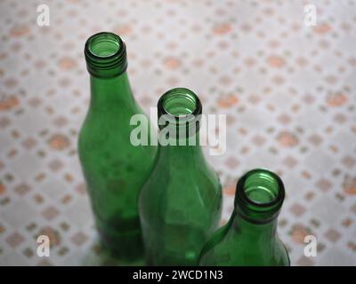 Three Empty Green Wine Bottles On A Table With Copy Space Stock Photo