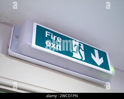 Fire Exit Sign Above Green Wooden Door Stock Photo