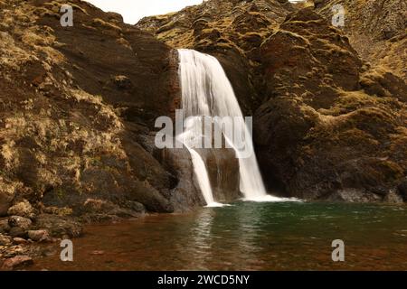 Helgufoss is a waterfall near the capital of Iceland, located in Mosfellsdalur valley Stock Photo