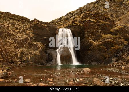 Helgufoss is a waterfall near the capital of Iceland, located in Mosfellsdalur valley Stock Photo