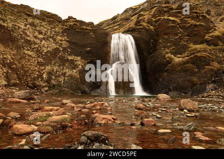 Helgufoss is a waterfall near the capital of Iceland, located in Mosfellsdalur valley Stock Photo