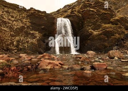 Helgufoss is a waterfall near the capital of Iceland, located in Mosfellsdalur valley Stock Photo