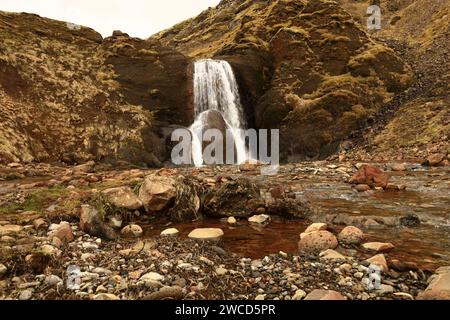 Helgufoss is a waterfall near the capital of Iceland, located in Mosfellsdalur valley Stock Photo