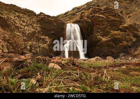 Helgufoss is a waterfall near the capital of Iceland, located in Mosfellsdalur valley Stock Photo