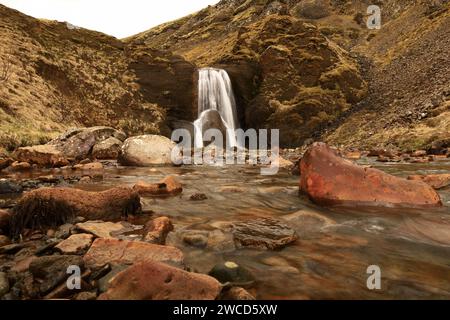 Helgufoss is a waterfall near the capital of Iceland, located in Mosfellsdalur valley Stock Photo