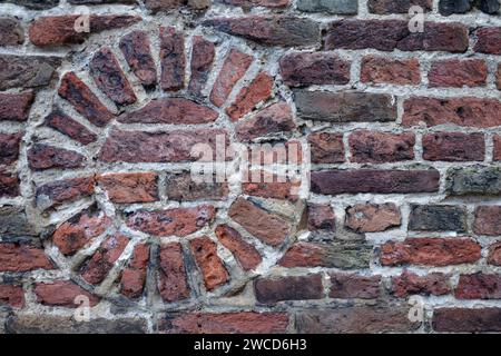 Part of a very old wall from the Middle Ages with stones laid in a round shape. Stock Photo