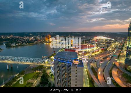 Cincinnati, Ohio, modern American city with high-rise office buildings and highway junction at night with fast driving cars. Aerial view of USA urban Stock Photo