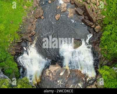 An Aerial shot of Blackwater Falls cascading through rugged terrain in West Virginia's lush landscape Stock Photo