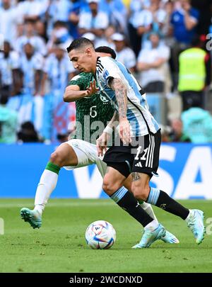 Ángel Di María attempts to dribble past Saudi Arabian defender, Mohammed Al-Burayk, during Argentina's Group Stage loss in the 2022 FIFA World Cup. Stock Photo