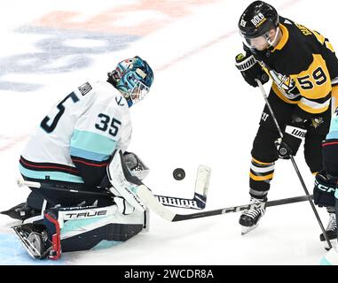 Seattle Kraken goaltender Joey Daccord (35) knocks the puck away with ...