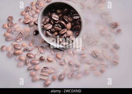 Image of coffee beans on background with smoke Stock Photo