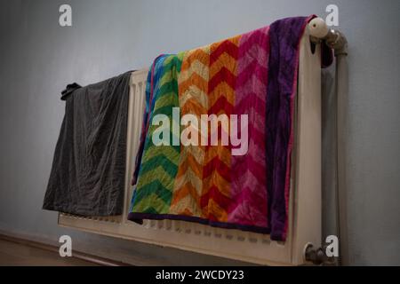 towel and t shirt drying on radiator Stock Photo