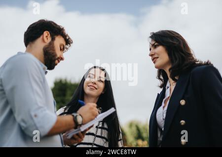Students Collaborating Outdoors for Academic Success Stock Photo