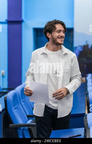 Satisfied, male student about to leave the exam. He successfully wrote all the answers. Stock Photo