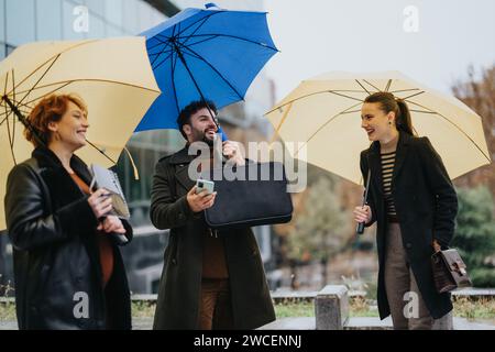 Diverse business team collaborates outdoors on a rainy day for profitability and sustainability. Stock Photo