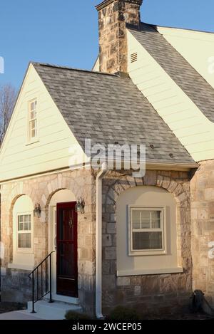 Stone House with Burgundy Colored Front Door Stock Photo