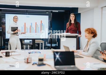 Business professionals discuss statistics and brainstorm for business expansion in a corporate office, fostering success through teamwork. Stock Photo